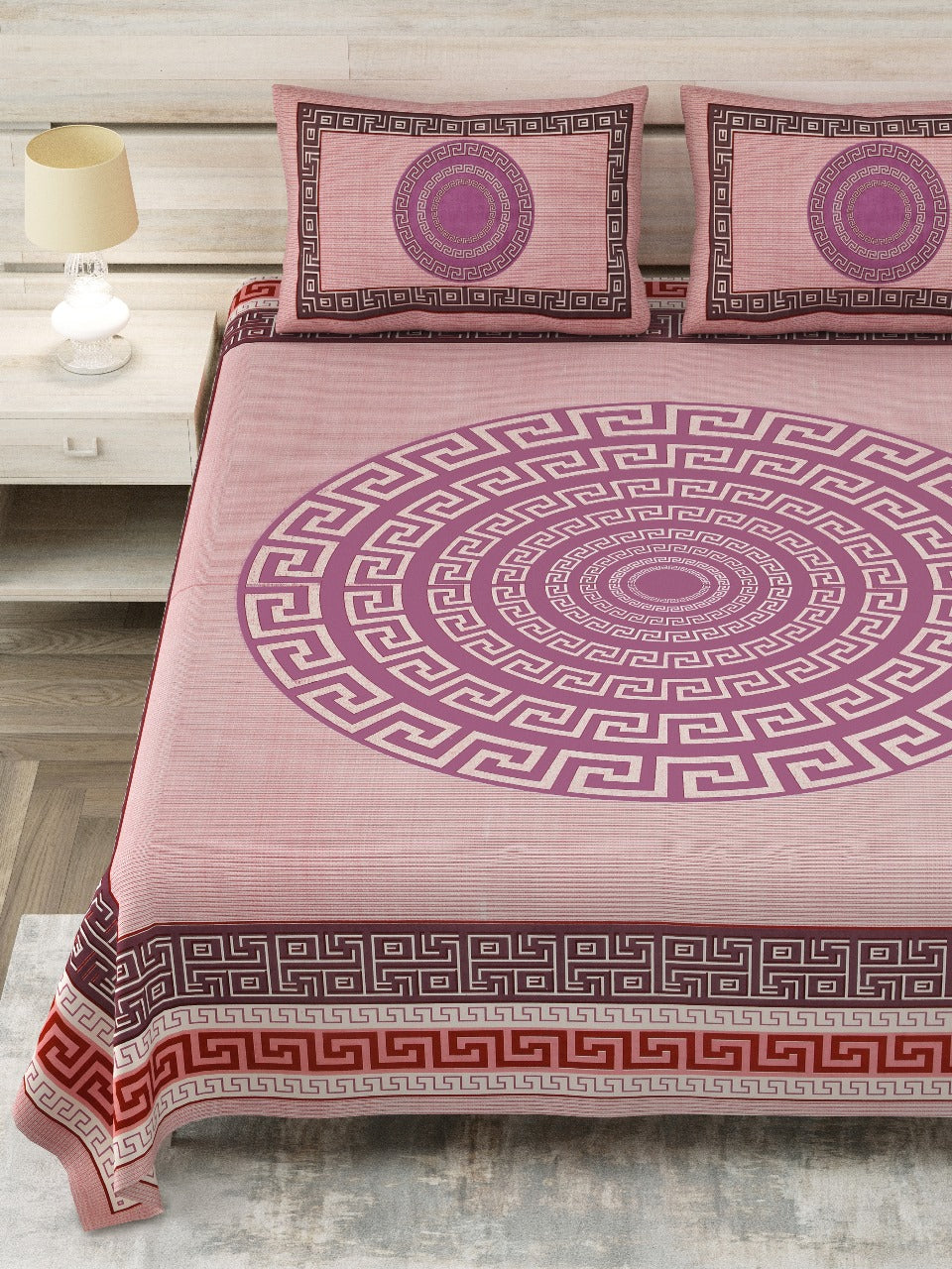 A king-size bed sheet set with a geometric pattern, including pillowcases, in a color palette that primarily features purple, pink, and other colors with a Greek key design.
