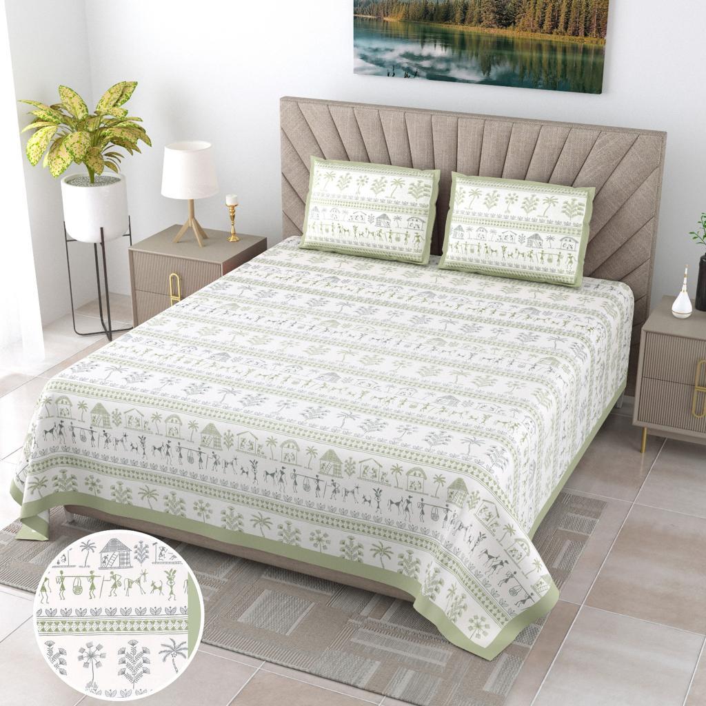 A jumbo king-size bed sheet set with a geometric pattern in green color, displayed on a bed in a furnished room, accompanied by two pillowcases.