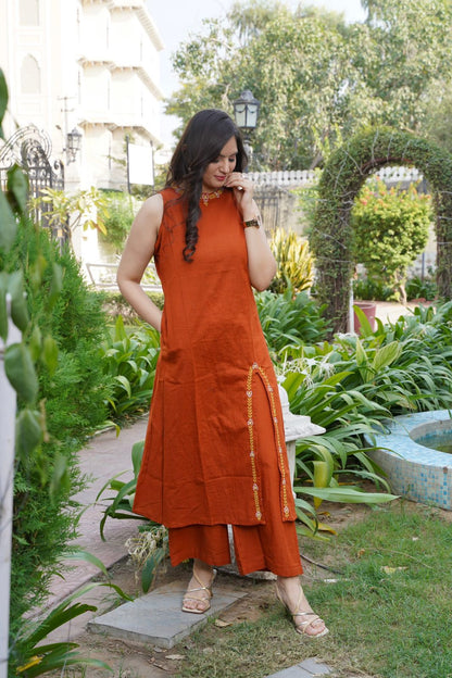 Woman in an orange dress standing in a garden