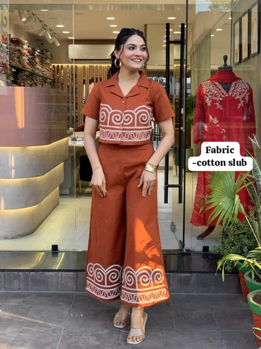 Woman wearing a brown outfit with white patterns in a store setting