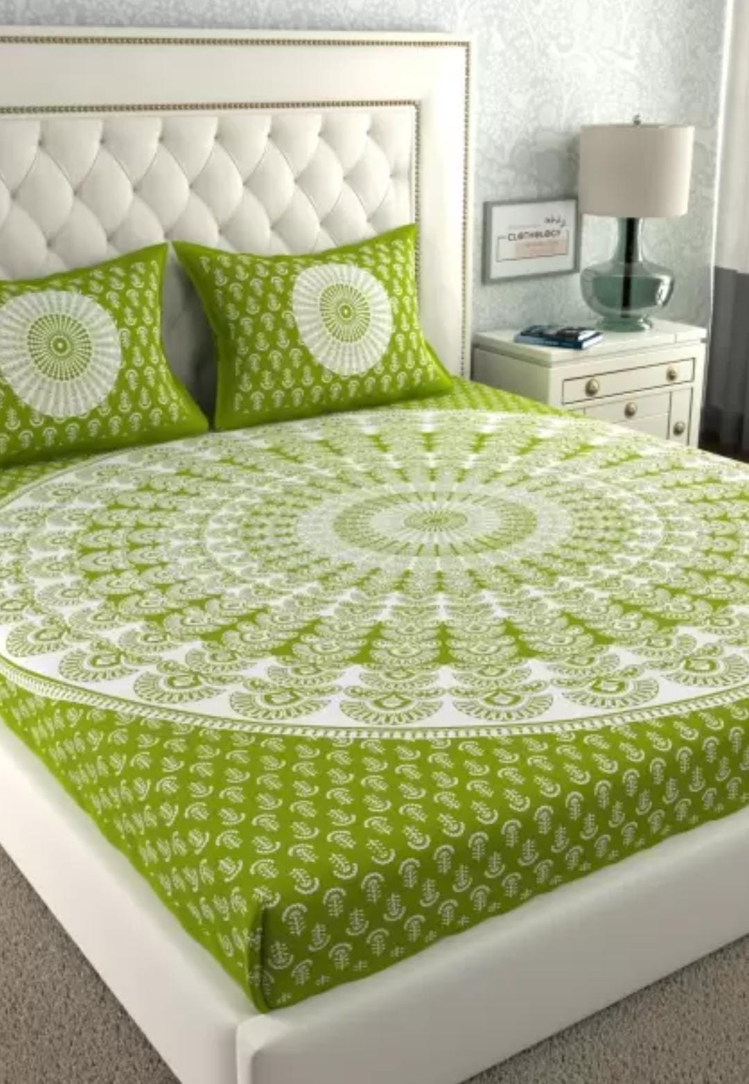 Green and white patterned bedspread on a bed with matching pillows in a bedroom setting.